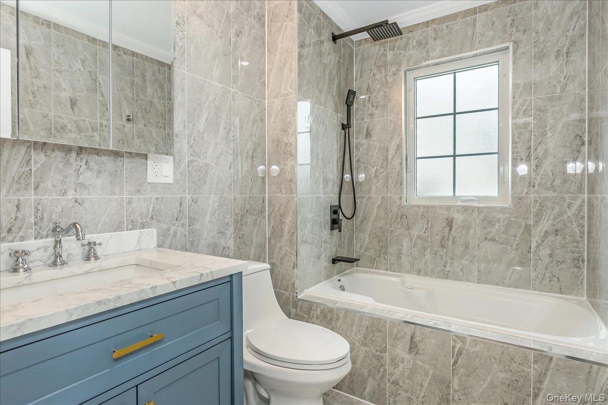 243-36 Caney Road Queens, NY 11422 - Photo 10 of 30 a bathroom with a sink a toilet and shower