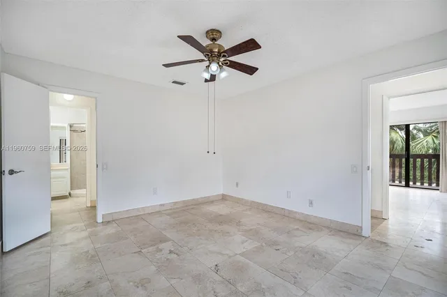 a view of a livingroom with a ceiling fan and window