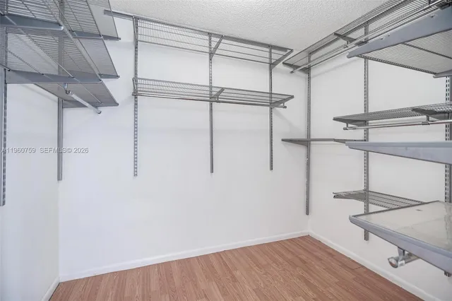 a view of a room with wooden floor