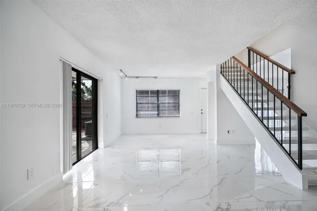 a view of an entryway with wooden floor