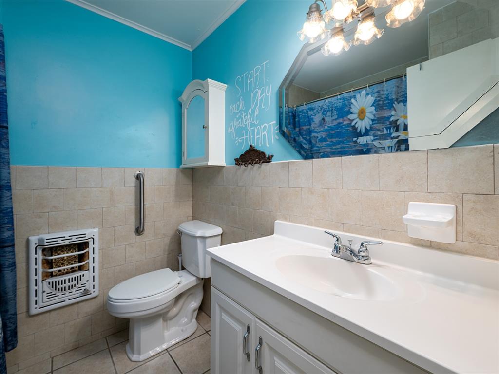 9663 Matise Street Tyler, TX 75706 - Photo 15 of 15 a bathroom with a sink a toilet and a mirror