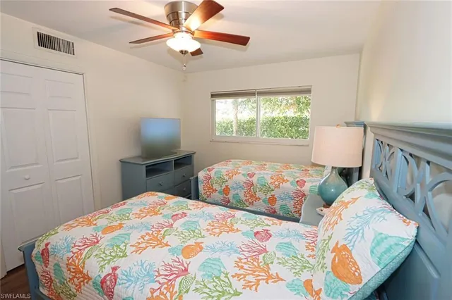 a bedroom with two beds and a window