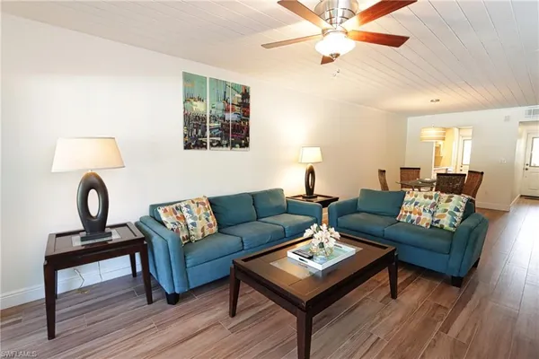 a living room with furniture and a wooden floor