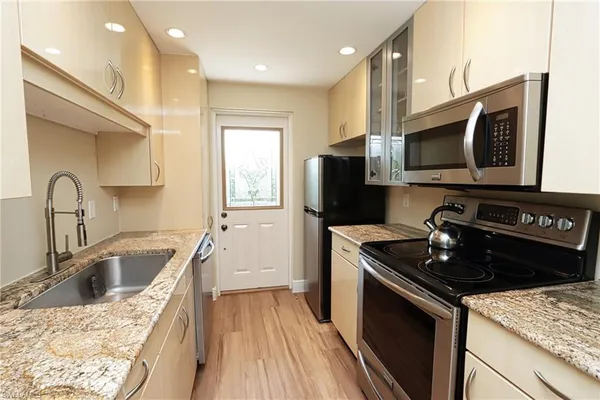 a kitchen with a sink stove and refrigerator
