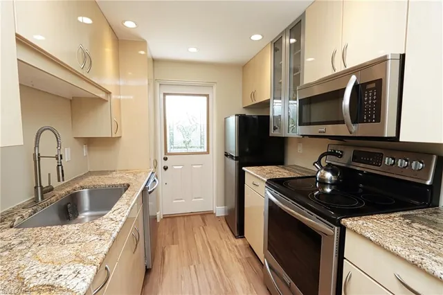 a kitchen with a sink stove and refrigerator
