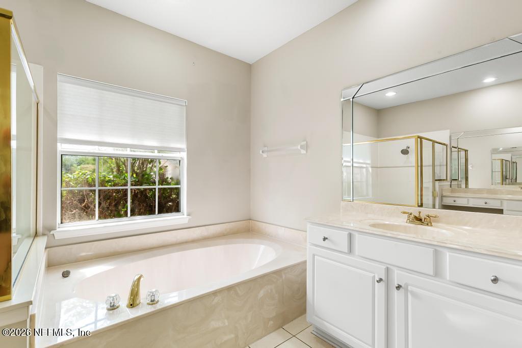 337 South Mill View Way Ponte Vedra Beach, FL 32082 - Photo 34 of 55 a bathroom with a granite countertop sink and a bathtub