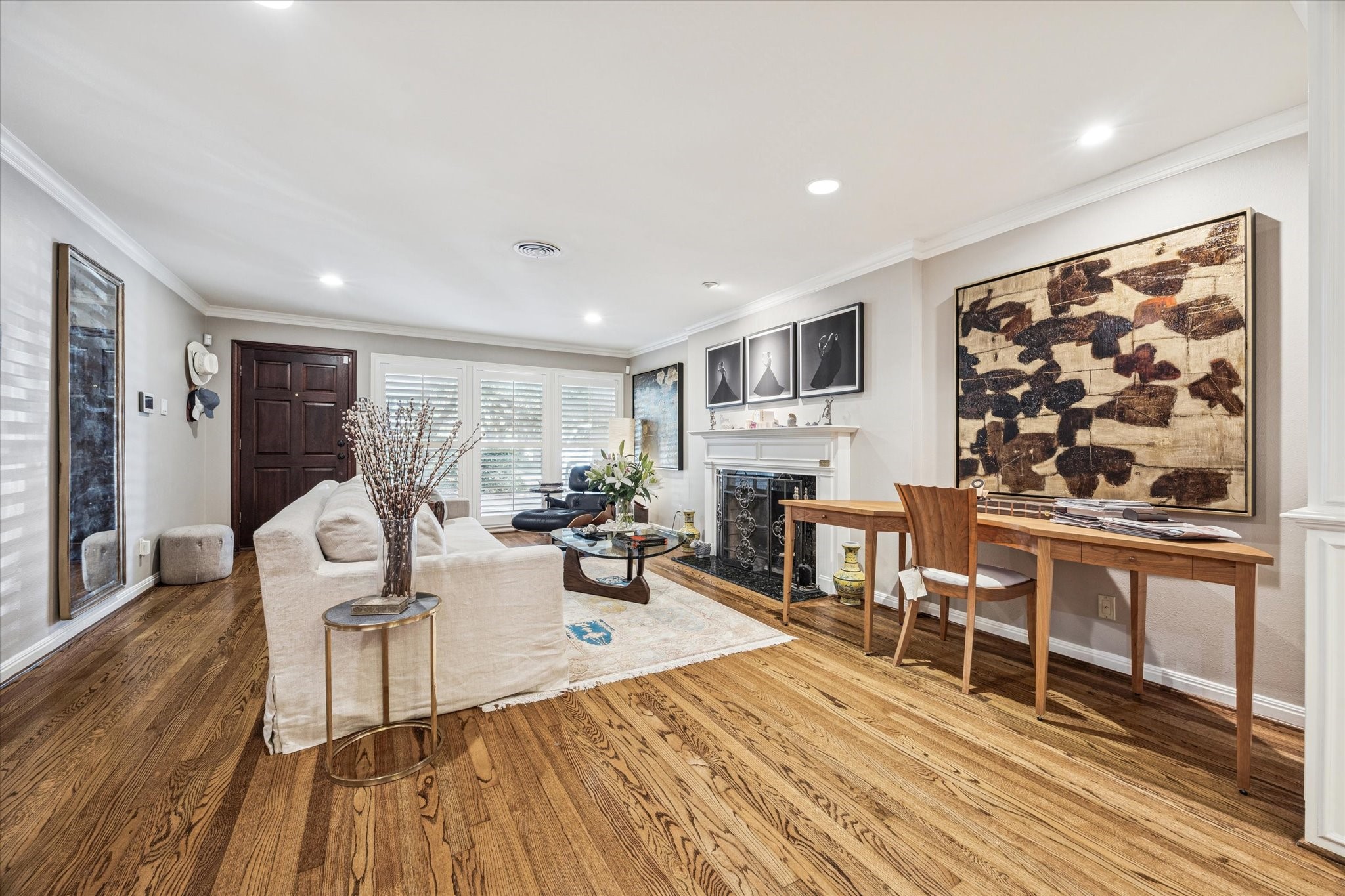 2401 Maconda Lane Houston, TX 77027 - Photo 3 of 20 The LIVING ROOM (22 X 15) includes front entry wood front door, hardwood flooring, painted walls, crown/base molding, recessed lighting, series of windows overlooking covered Front Entry Porch, fireplace (painted wood mantel/stone surround).
