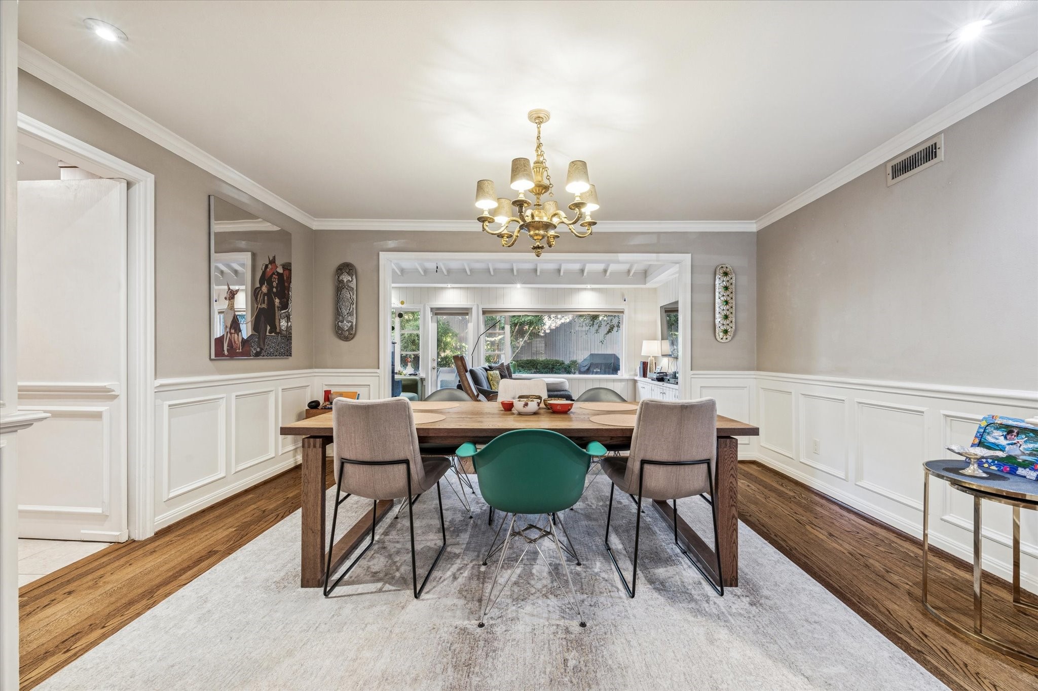 2401 Maconda Lane Houston, TX 77027 - Photo 4 of 20 The DINING ROOM (15 X 10) features hardwood flooring, painted wainscotting, painted walls, crown/base molding, central chandelier, swinging door to Kitchen and access to the adjacent Sun Room/Den which overlooks the Backyard.