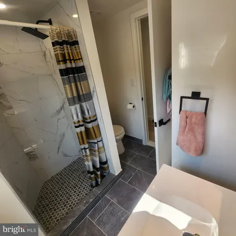 a bathroom with a toilet and a shower