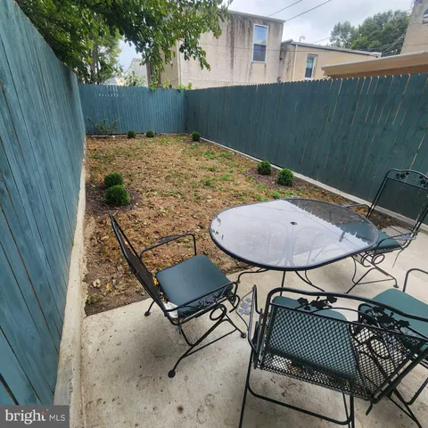 a backyard of a house with table and chairs