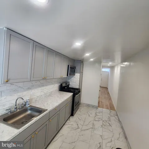 a kitchen with a sink and a stove top oven