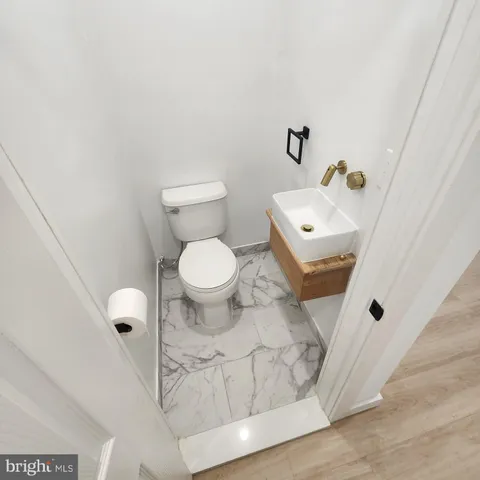 a white toilet sitting next to a bathroom sink