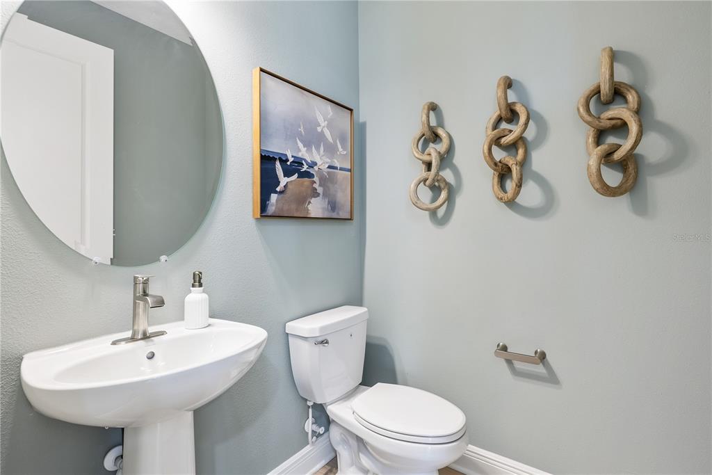 17966 Broadleaf Loop Venice, FL 34293 - Photo 16 of 19 a bathroom with a toilet sink and mirror