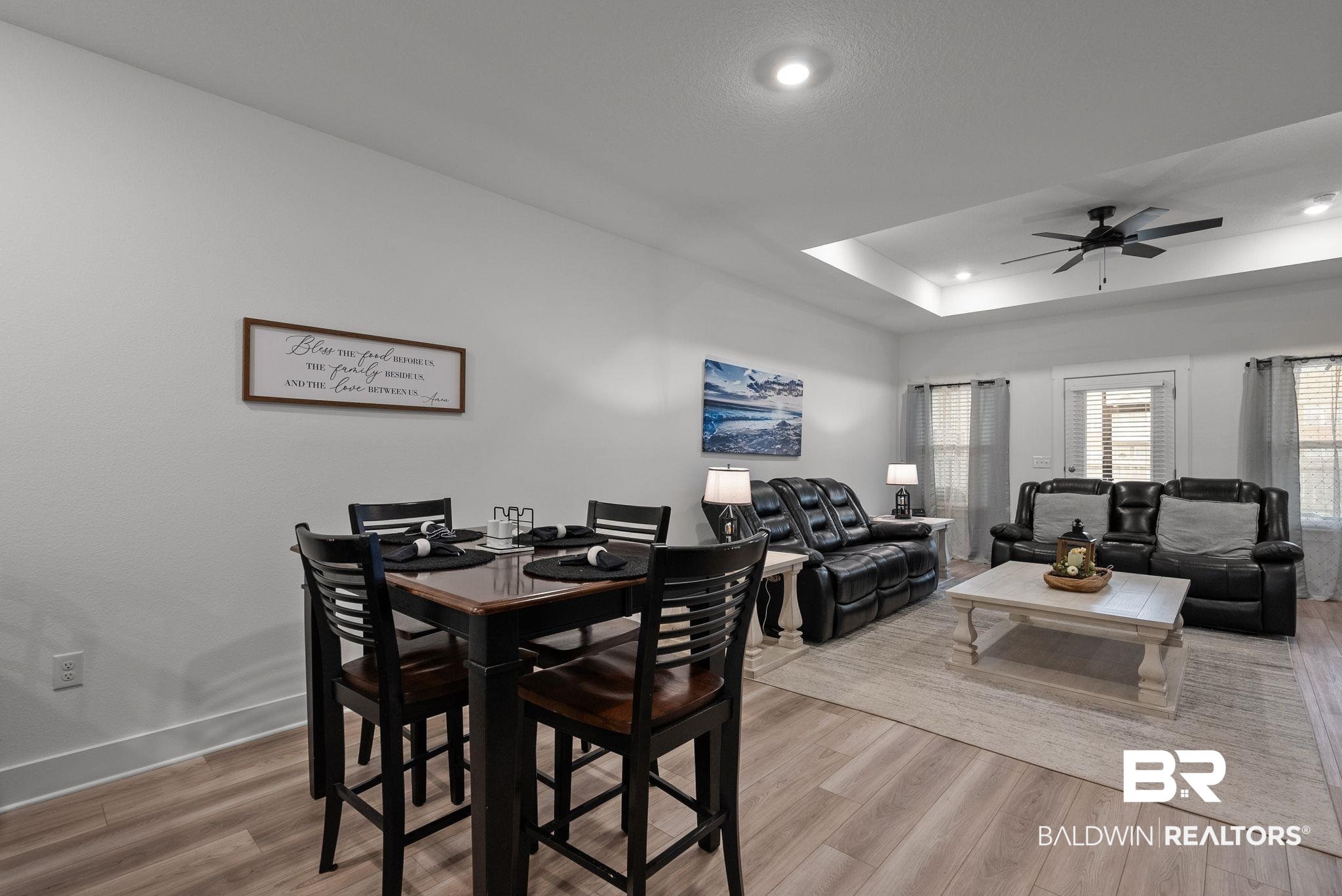 9899 Willet Way Foley, AL 36535 - Photo 9 of 37 Open-concept living space featuring wood-finish flooring, a tray ceiling with recessed lighting, and a ceiling fan
