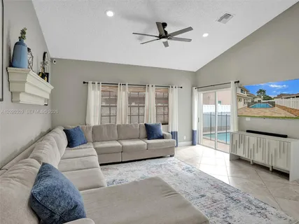 a kitchen with stainless steel appliances kitchen island granite countertop a table and chairs