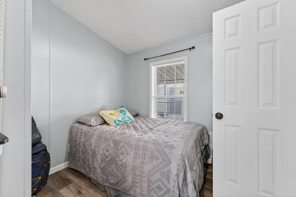 a bedroom with a bed and a window