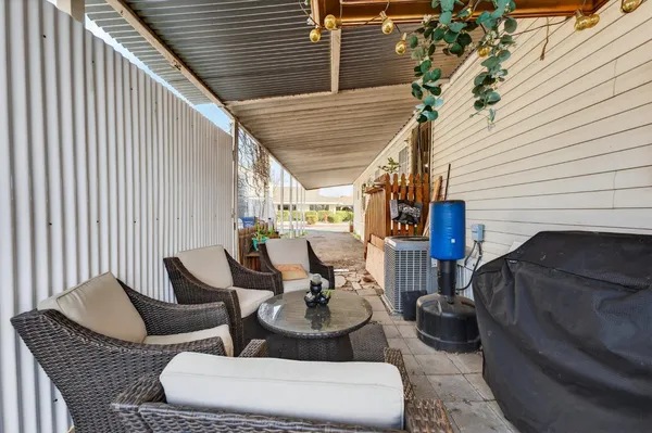 a view of a patio with couches chairs and a potted plant