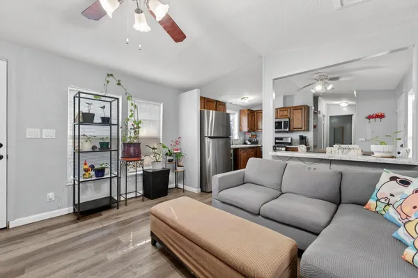 a living room with furniture and kitchen view