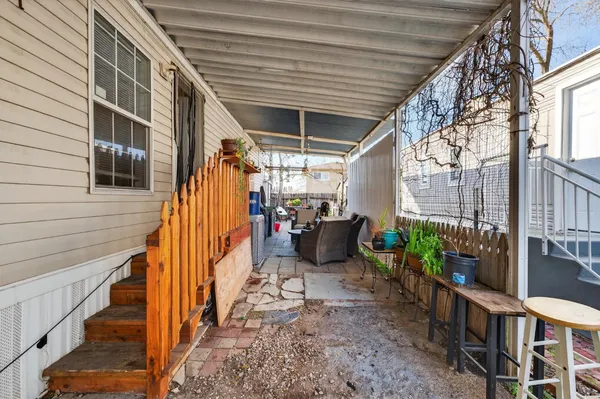 a front view of a house with a yard and potted plants