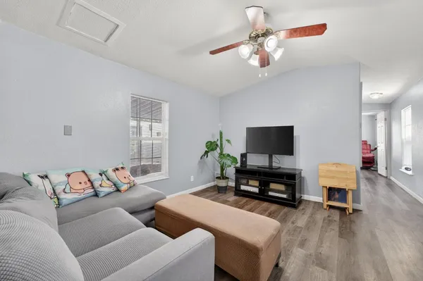 a living room with furniture and a flat screen tv