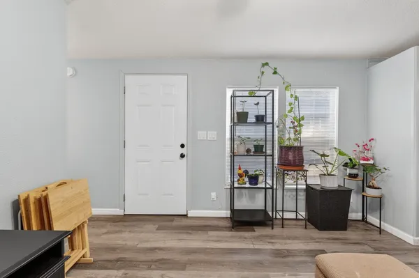 a living room with furniture and wooden floor