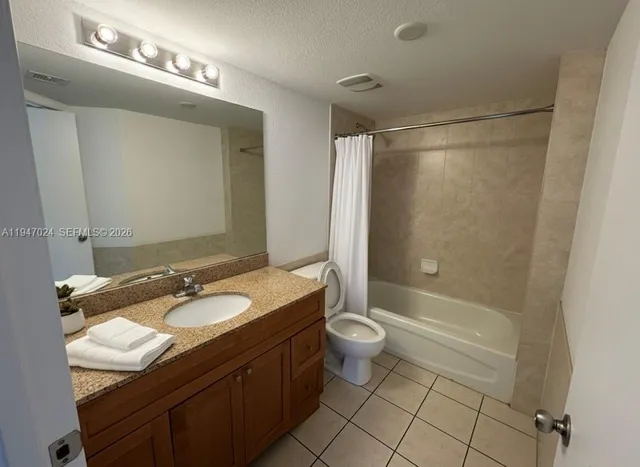 a bathroom with a double vanity sink toilet mirror and shower