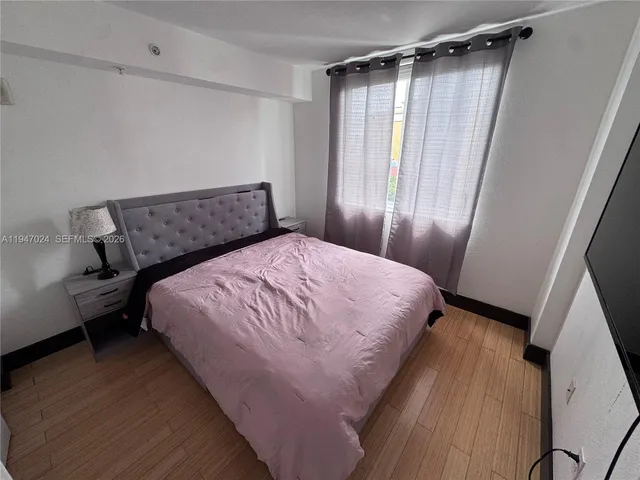 a bed sitting in a bedroom next to a window