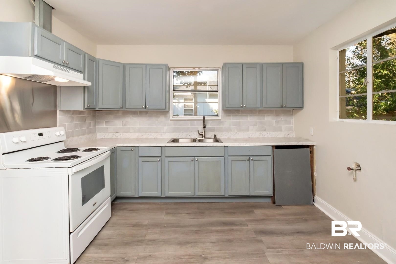 292 Siena Vista Street Mobile, AL 36607 - Photo 7 of 30 Kitchen featuring white range with electric cooktop, tasteful backsplash, gray cabinets, a sink, and under cabinet range hood