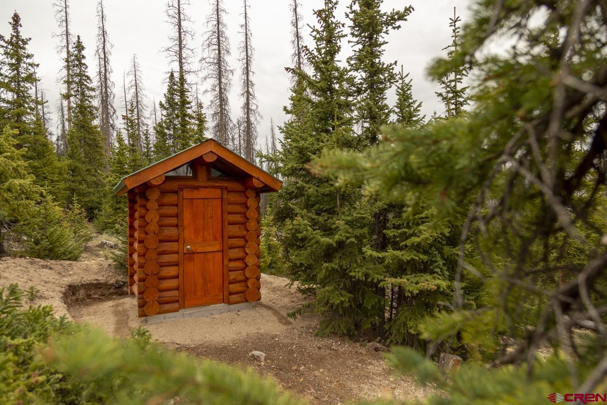 3190 Forest Road, Unit 503 Creede, CO 81130 - Photo 12 of 22 a front view of a house with a yard