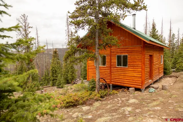 a view of a house with a yard and wooden fence