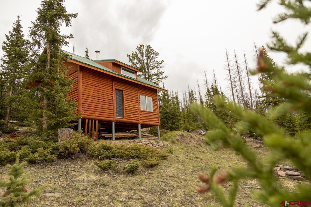 3190 Forest Road, Unit 503 Creede, CO 81130 - Photo 16 of 22 a backyard of a house with a garden and outdoor seating