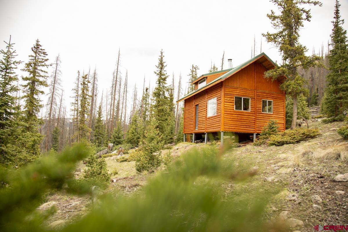 3190 Forest Road, Unit 503 Creede, CO 81130 - Photo 4 of 22 a view of a house with a yard and sitting area