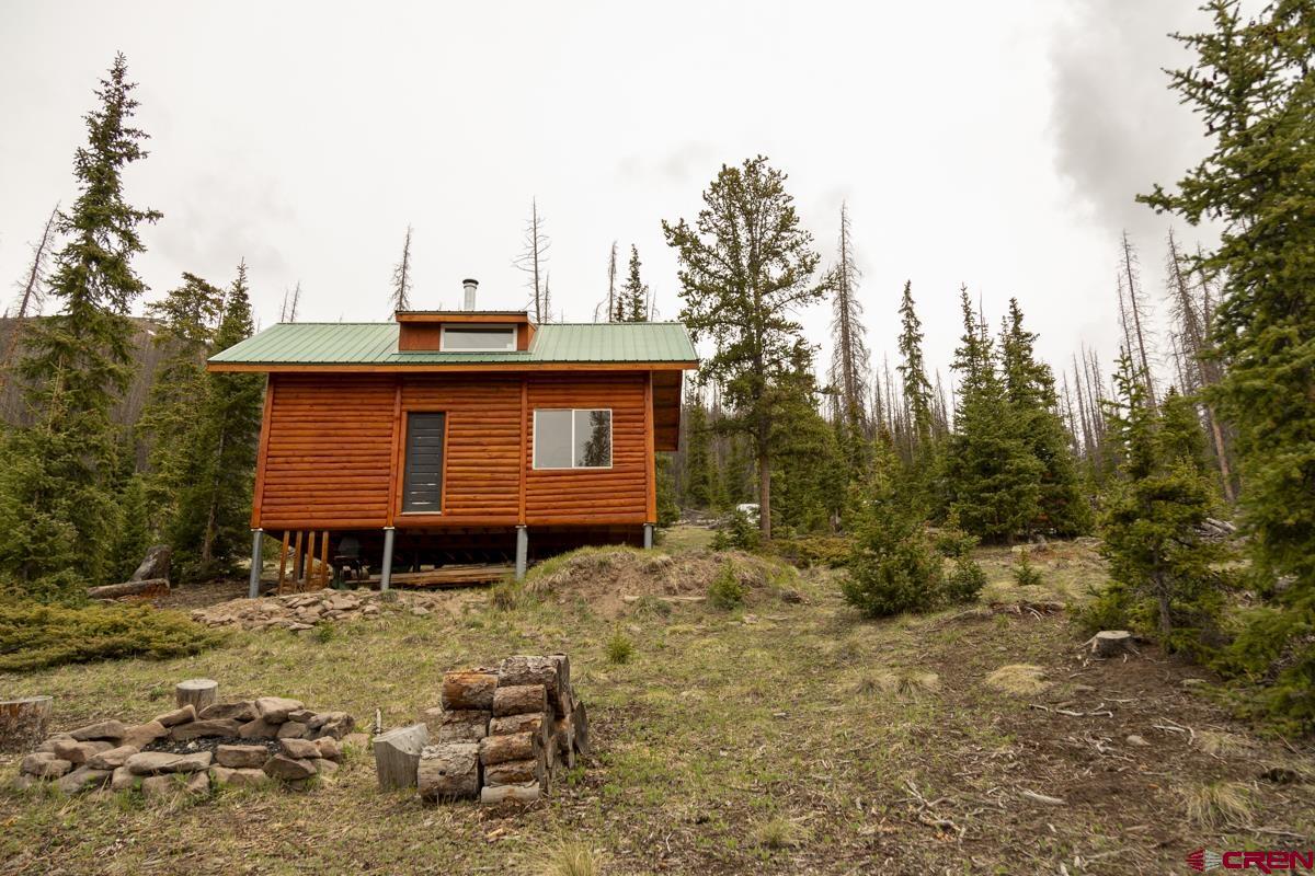 3190 Forest Road, Unit 503 Creede, CO 81130 - Photo 9 of 22 a front view of a house with a yard