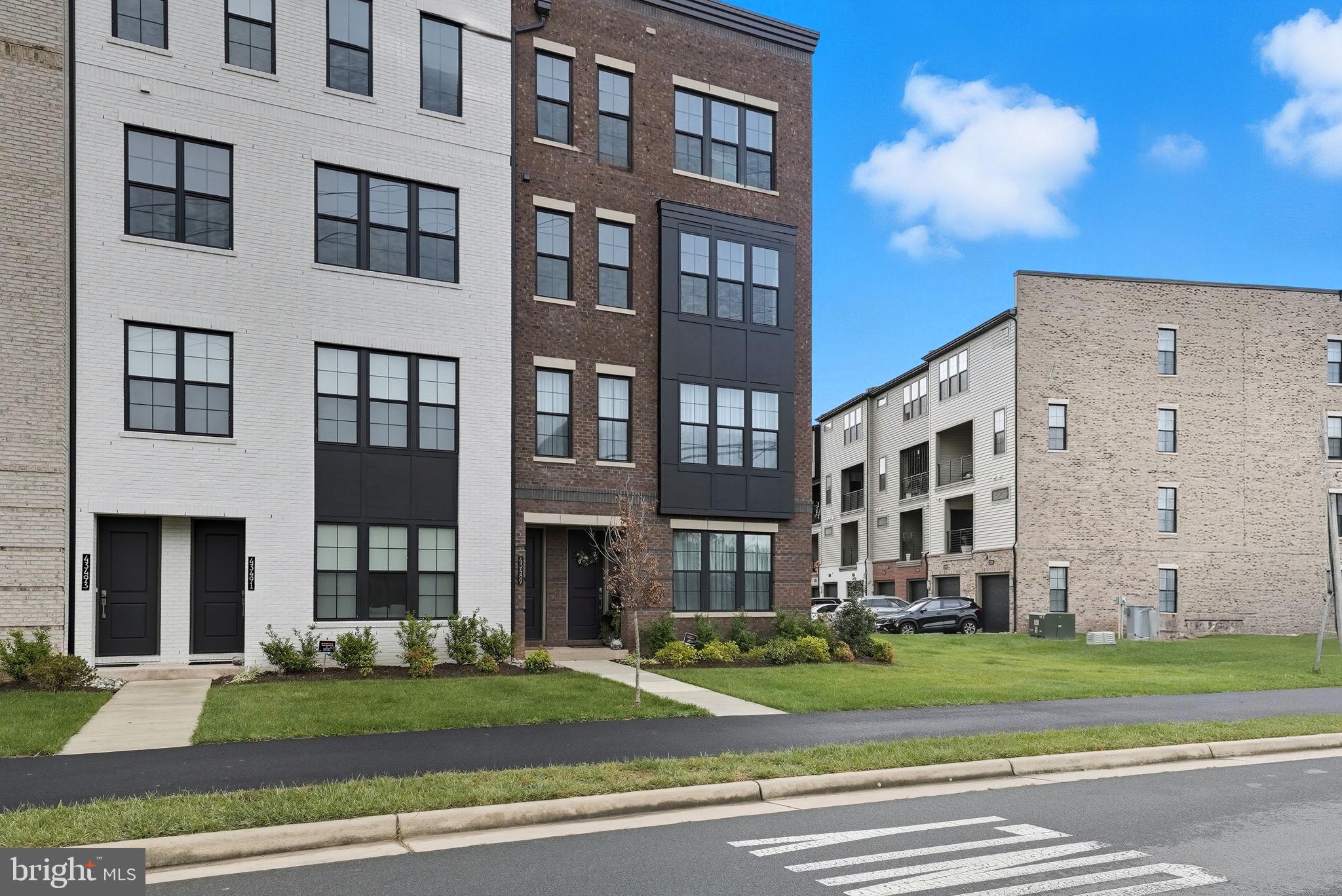 43489 Old Ryan Road Ashburn, VA 20148 - Photo 22 of 30 a view of a brick building next to a yard