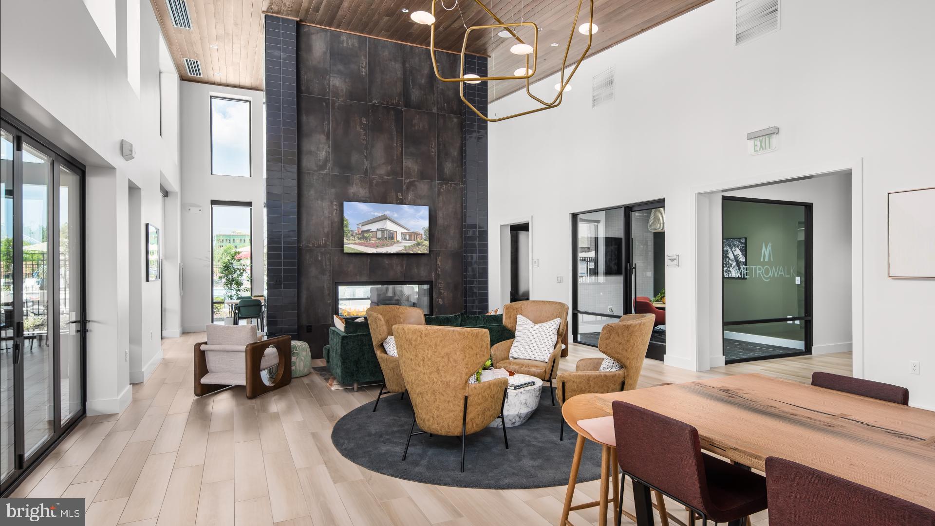 43489 Old Ryan Road Ashburn, VA 20148 - Photo 26 of 30 a dining room with wooden floor a chandelier a glass table and chairs