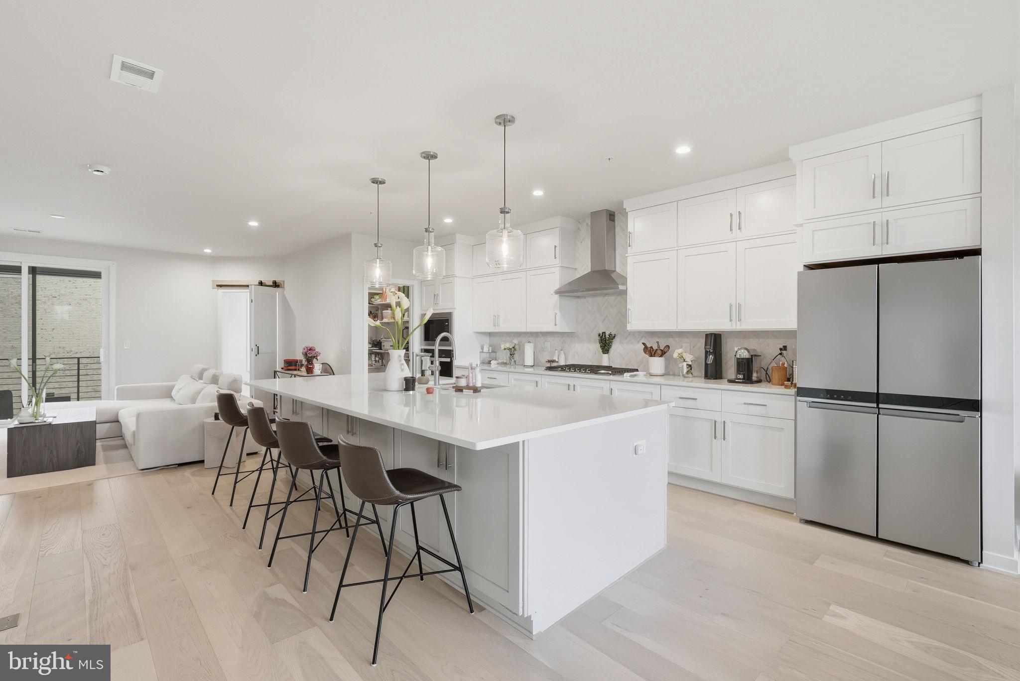43489 Old Ryan Road Ashburn, VA 20148 - Photo 3 of 30 a kitchen with white cabinets and white appliances