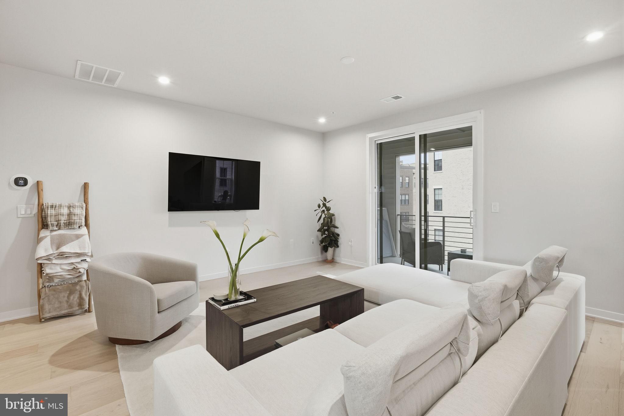43489 Old Ryan Road Ashburn, VA 20148 - Photo 5 of 30 a living room with furniture and a flat screen tv