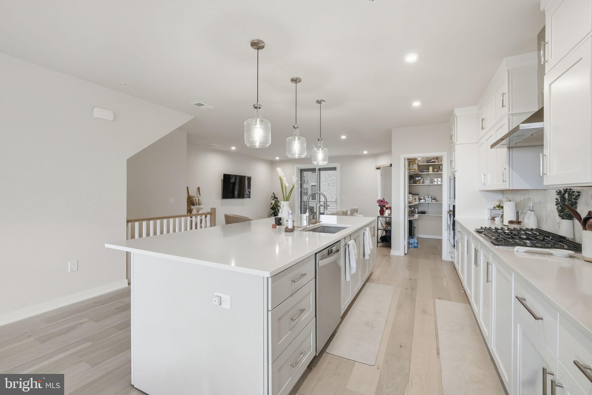 43489 Old Ryan Road Ashburn, VA 20148 - Photo 7 of 30 a kitchen with stainless steel appliances a sink stove and cabinets
