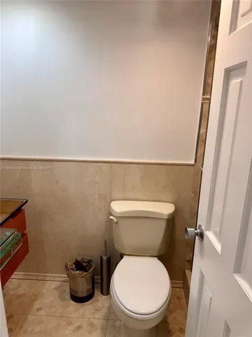 a white toilet sitting next to a sink