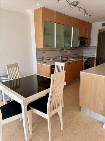 a dining room with furniture and a large window