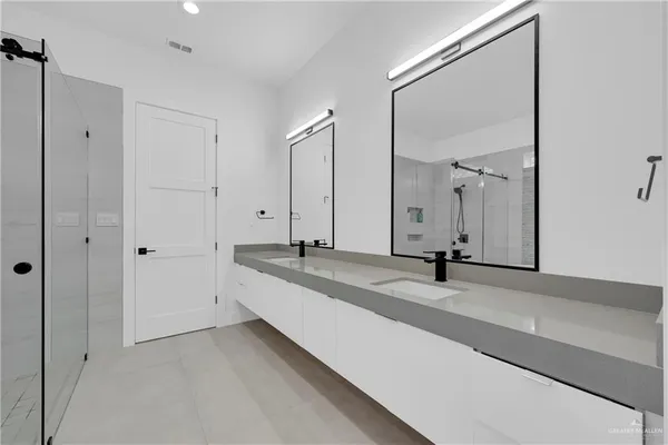 a bathroom with a double vanity sink and a mirror
