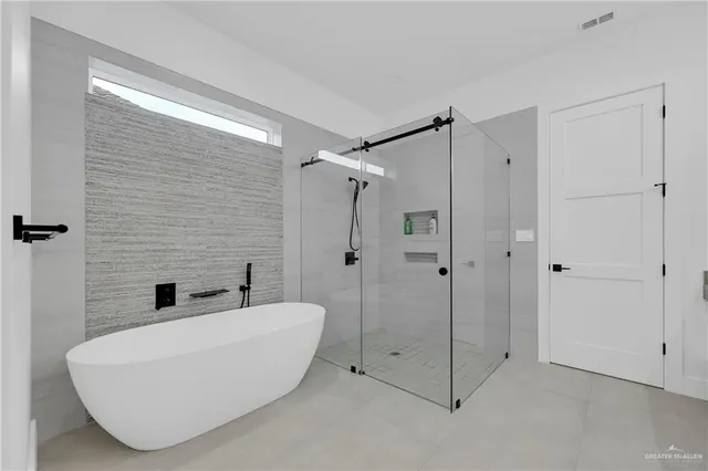 a bathroom with a tub and shower