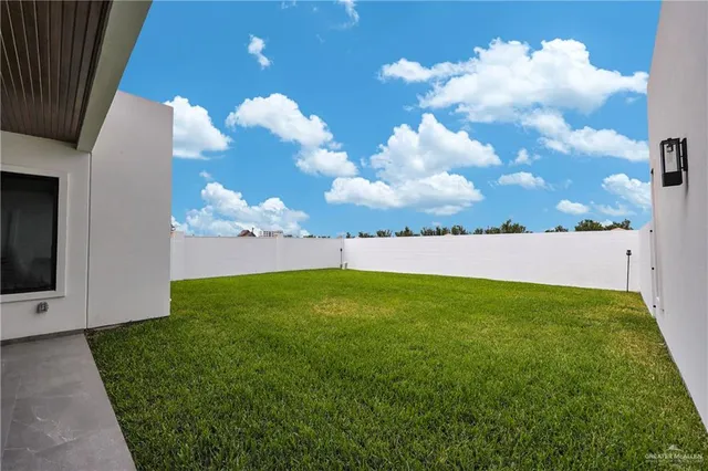 a view of a big yard with an entryway