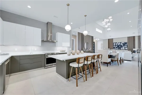 a large kitchen with a table and chairs