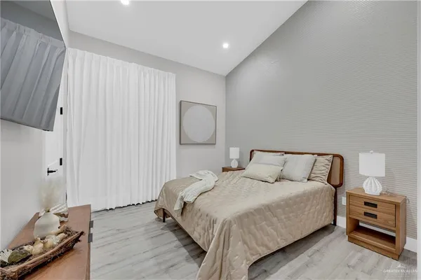 a bedroom with a bed and wooden floor