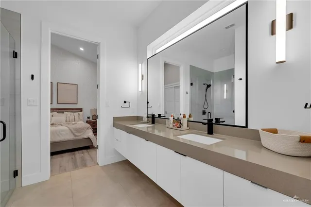 a en suite bathroom with double sink and mirror