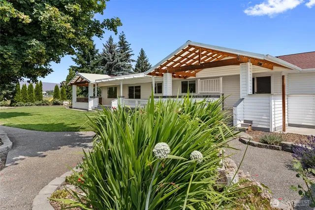 a front view of a house with a garden