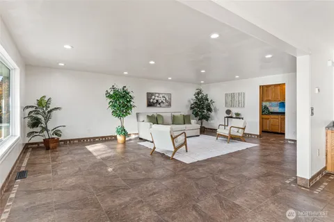 a living room with furniture and a potted plant