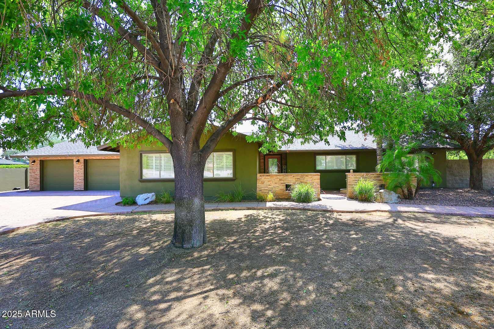 5449 East Thunderbird Road Scottsdale, AZ 85254 - Photo 1 of 75 a front view of a house with a yard and a garage