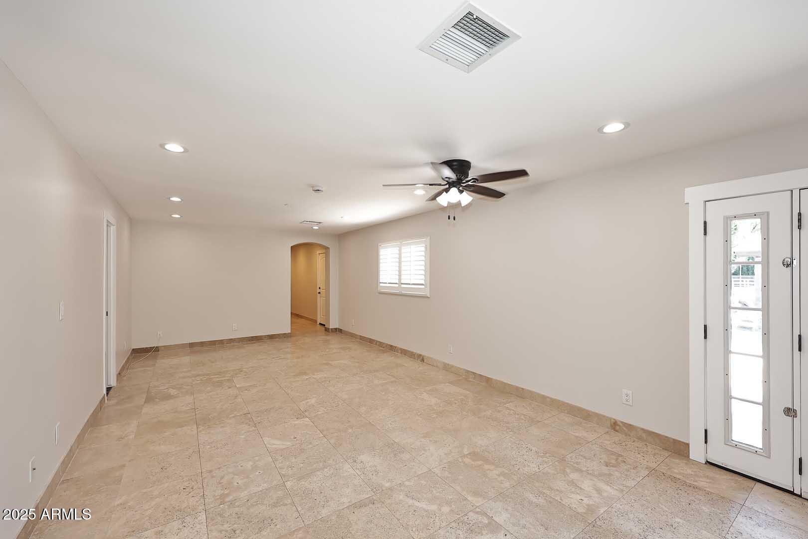 5449 East Thunderbird Road Scottsdale, AZ 85254 - Photo 16 of 75 en empty room with windows and ceiling fan